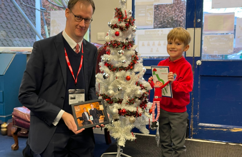 Tom Randall MP with the Ruari, age 5, at Westdale Infant School holding the winning entry he designed alongside Tom Randall MP holding a framed photo of the Prime Minister receiving Ruari’s design.